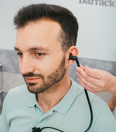 A man having a hearing assessment